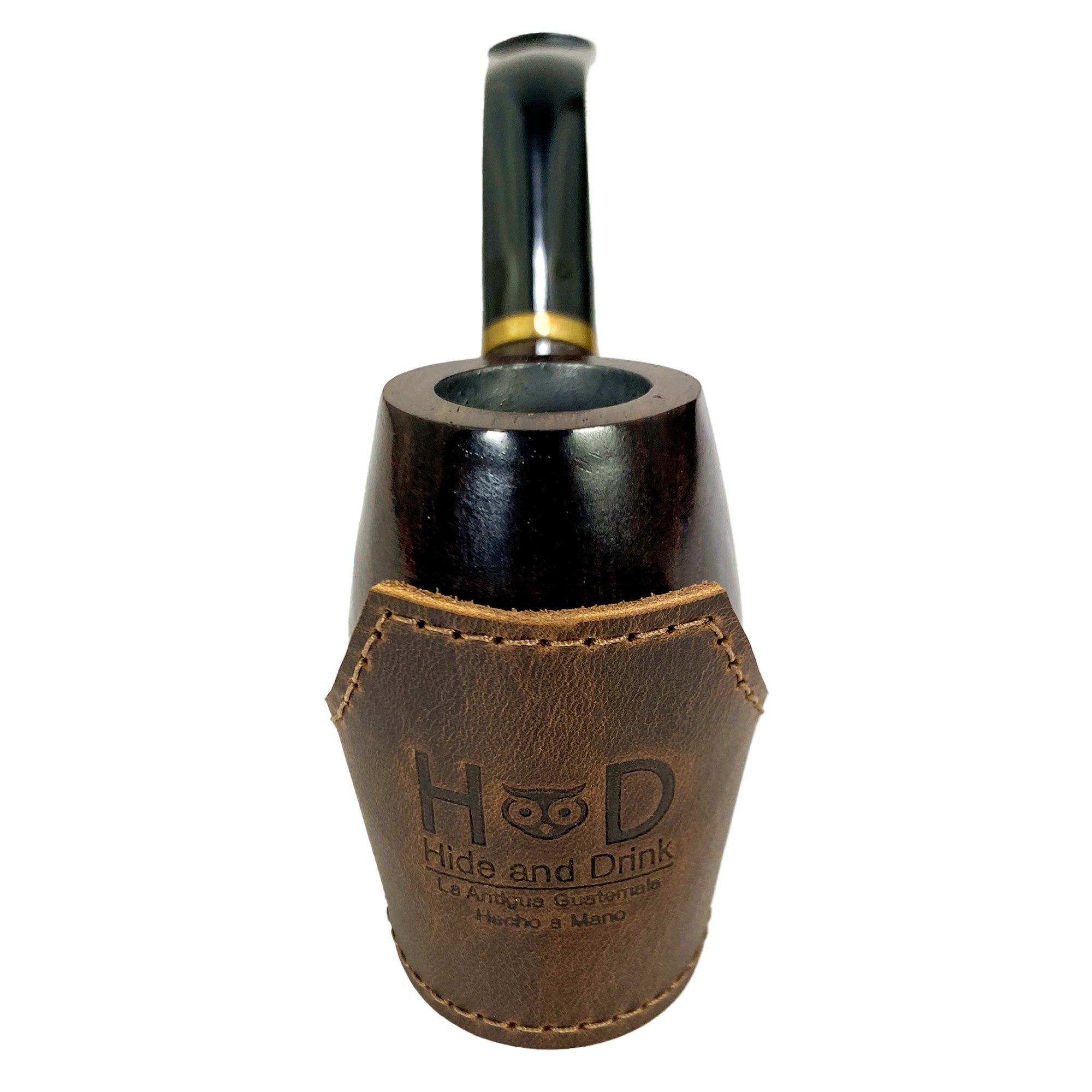 Close-up of the Tobacco Pipe Holder by Hide & Drink with a pipe and tobacco on a leather surface. This Tobacco Pipe Holder (Pipe not Included) serves as a portable & adjustable stand, enhancing your smoking accessories collection. Crafted from full grain leather through small batch production, it's a handmade, fire branded product from artisans in La Antigua Guatemala & Oaxaca Mexico.