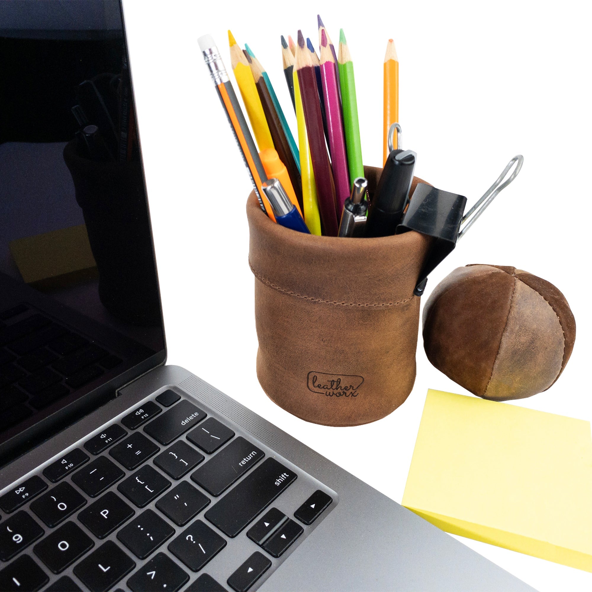 Leather Worx Pen Organizer beside a laptop, enhancing your workspace aesthetics. This Pen Organizer Cylinder Pencil Holder is a versatile work accessory made from Full Grain Leather, highlighting artisan quality and small batch production in La Antigua Guatemala & Oaxaca Mexico.