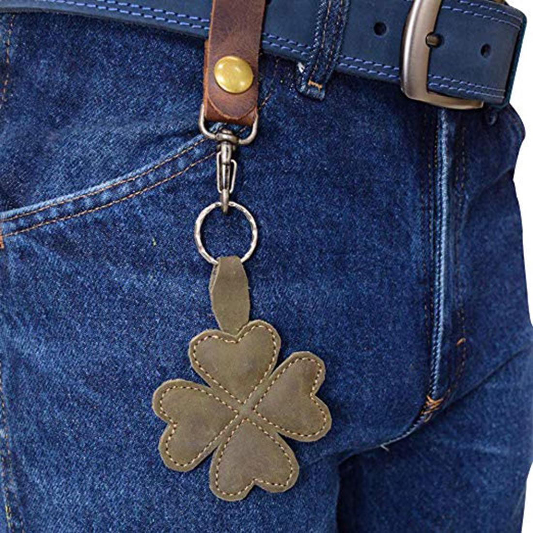 The St. Patrick's - Lucky Clover Keychain by Hide & Drink attached to a belt loop, emphasizing its practicality. This four-leaf lucky clover key organizer holder combines style and function with artisan craftsmanship, made from high-quality full grain leather.