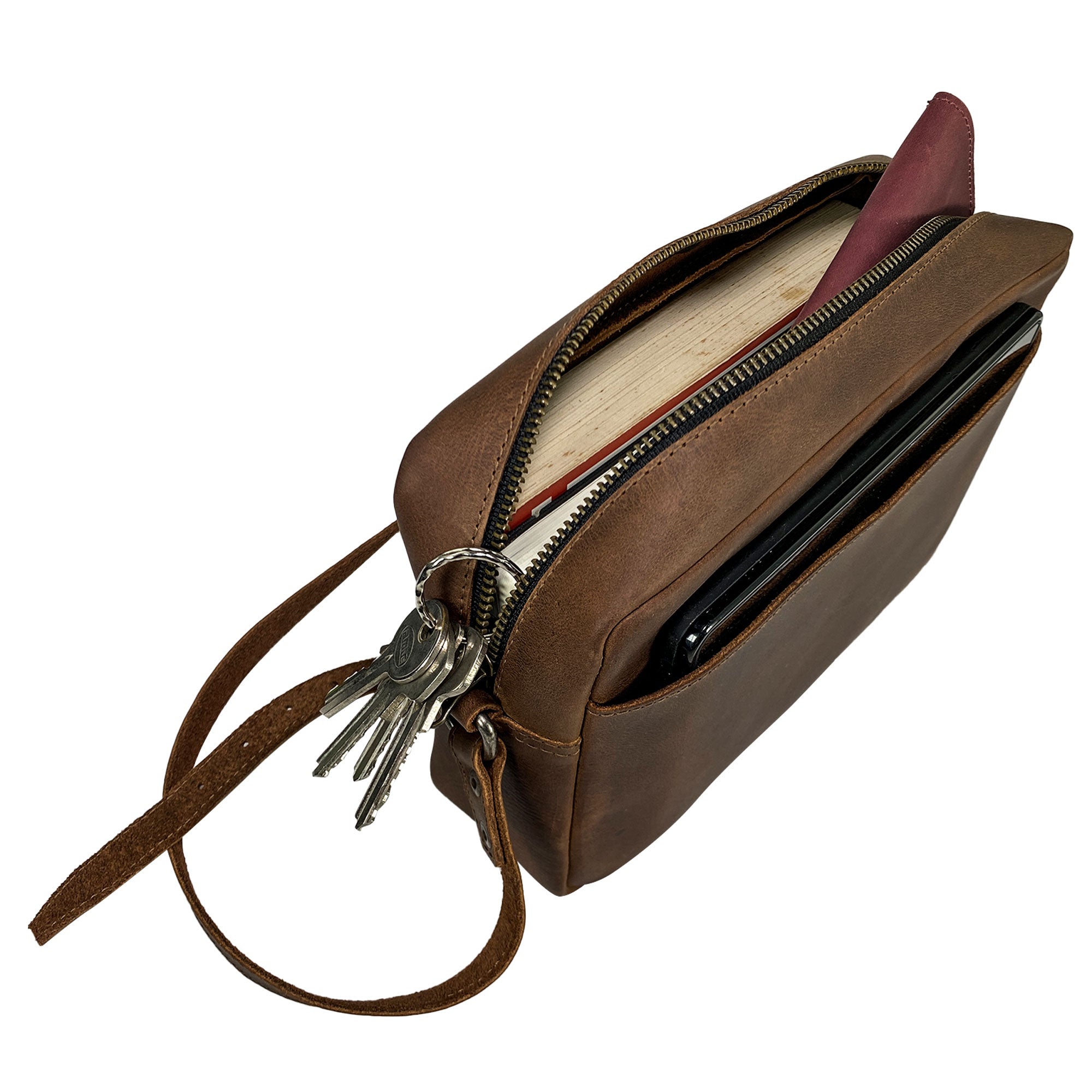 Overhead view of Heather's Rectangular Crossbody Bag filled with daily essentials, underscoring its practical design and artisan quality, perfect for any occasion. Squared Crossbody Bag - Stylish Shoulder Bag for Everyday Use or Travel, Full Grain Leather, StockyardX, Small Batch Production, Hand Cut, Hand Sewn, Fire Branded, Artisan, Handmade in La Antigua Guatemala & Oaxaca Mexico.