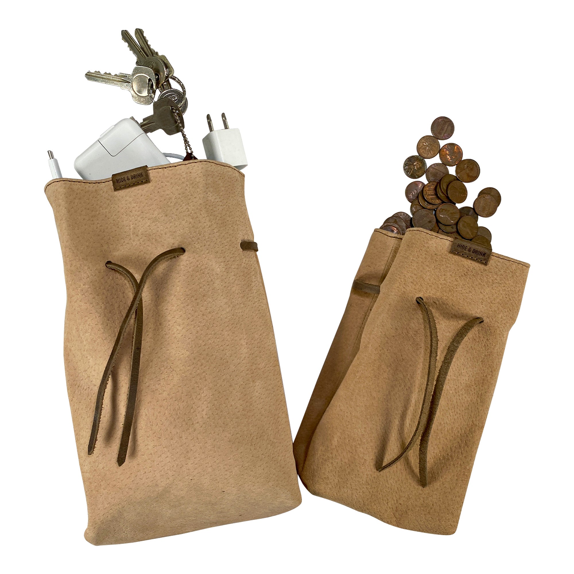 A functional display of Hide & Drink's Drawstring Sack (2 pack) filled with everyday items, showing its versatile use. Drawstring Sack (2 pack) Handmade from Sheepskin and Full Grain Leather, StockyardX, Small Batch Production, Hand Cut, Hand Sewn, Fire Branded, Artisan, Handmade in La Antigua Guatemala & Oaxaca Mexico.