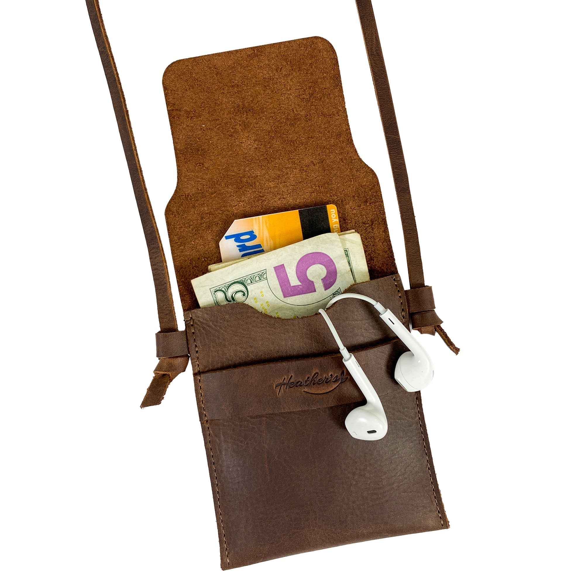 Mini Travel Bag by Heather's featuring cash and headphones inside, illustrating its versatility. This Mini Travel Bag Handmade from Full Grain Leather serves as a classic organizer, coin pouch, and storage case for ID, credit cards, and cash. StockyardX, Small Batch Production, Hand Cut, Hand Sewn, Fire Branded, Artisan, Handmade in La Antigua Guatemala & Oaxaca Mexico.