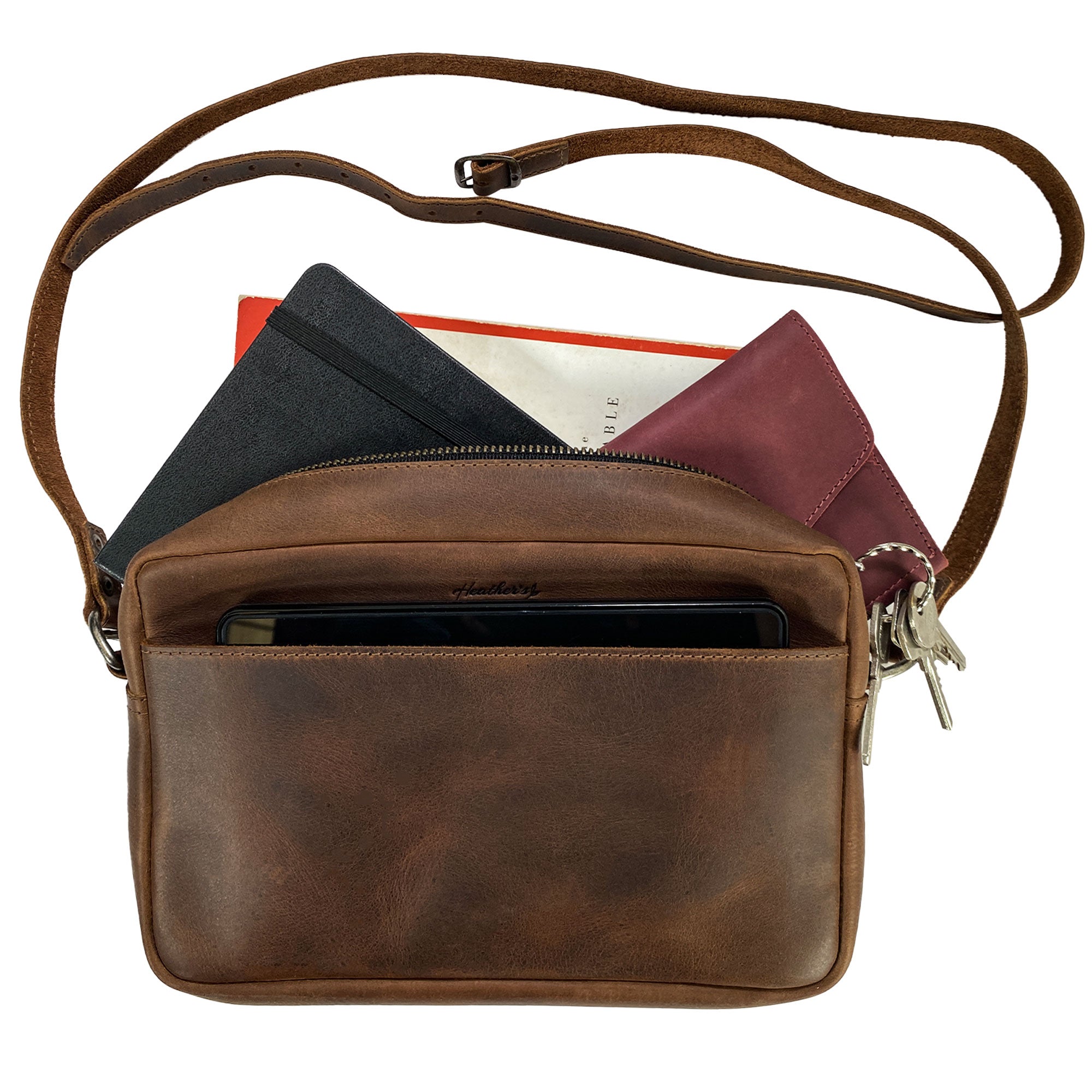 Front view of Heather's Rectangular Crossbody Bag with a greeting card, showcasing its artisan craftsmanship and suitability as a gift item for any occasion. Squared Crossbody Bag - Stylish Shoulder Bag for Everyday Use or Travel, Full Grain Leather, StockyardX, Small Batch Production, Hand Cut, Hand Sewn, Fire Branded, Artisan, Handmade in La Antigua Guatemala & Oaxaca Mexico.
