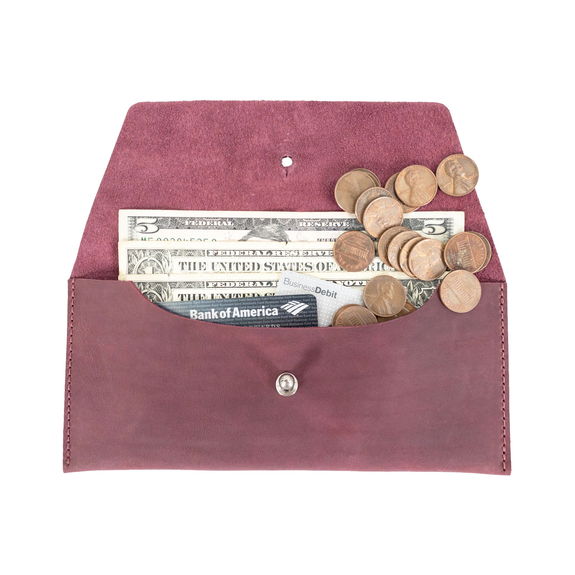 The Long Utility Pouch by Hide & Drink filled with coins and cash, showcasing its functionality and stylish design for everyday organization.