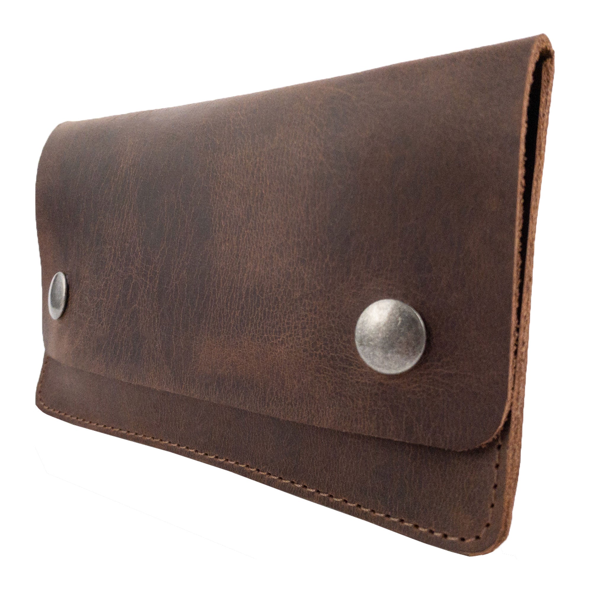 Side angle of the Double Snap Tobacco Pouch by Hide & Drink, displaying its sturdy design and rustic charm. This flat tobacco pouch is an ideal smoking case, made from high-quality full grain leather and perfect for on-the-go use. Handmade in small batches, it showcases rich artisan craftsmanship from La Antigua Guatemala.