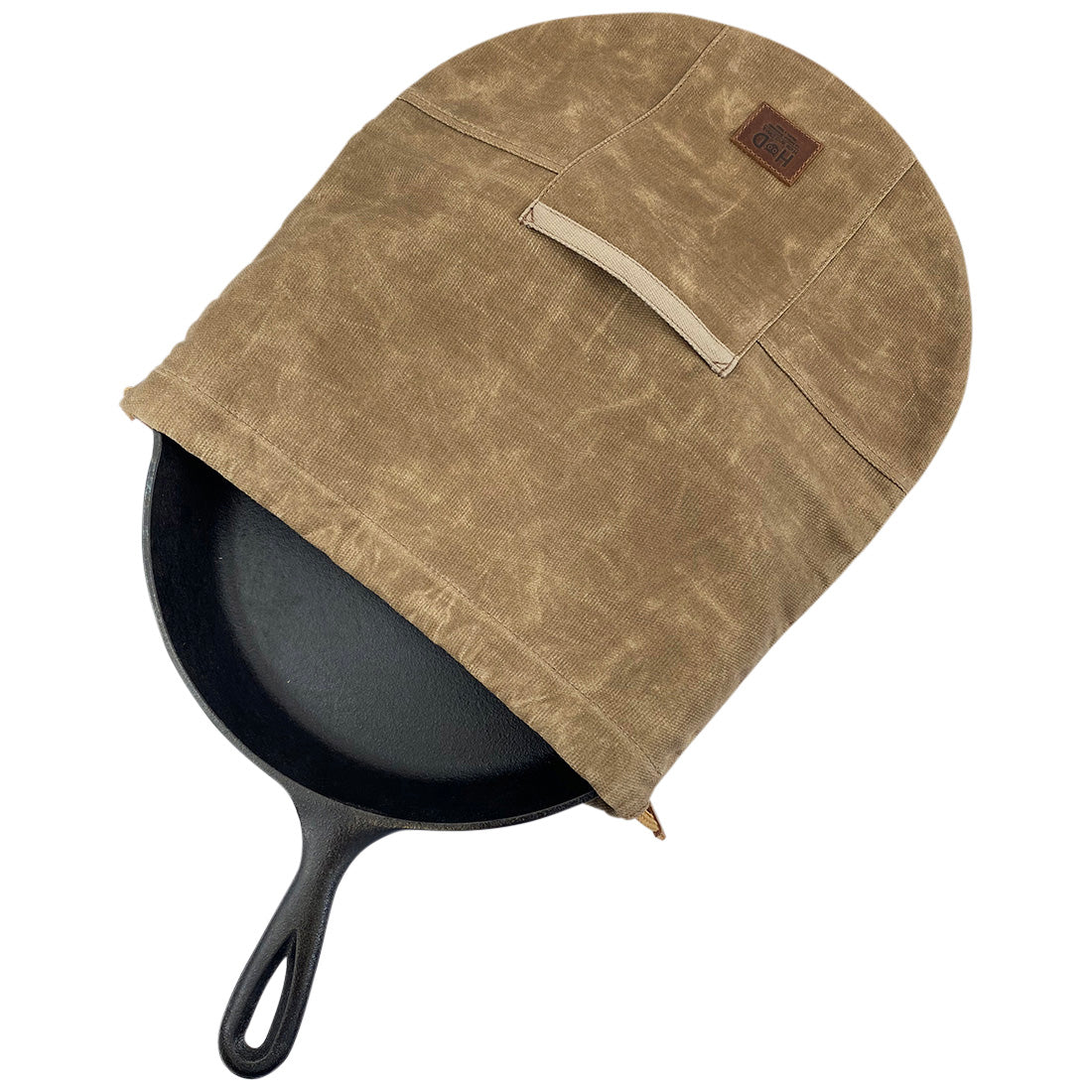 Skillet Bag Cover by Hide & Drink, shown with a cast iron skillet inside for protection. This rustic bag for a 12 Inch Frying Pan is made with durable, waxed canvas. Each piece is handmade in small batches, ensuring unique quality and craftsmanship from La Antigua Guatemala and Oaxaca Mexico.