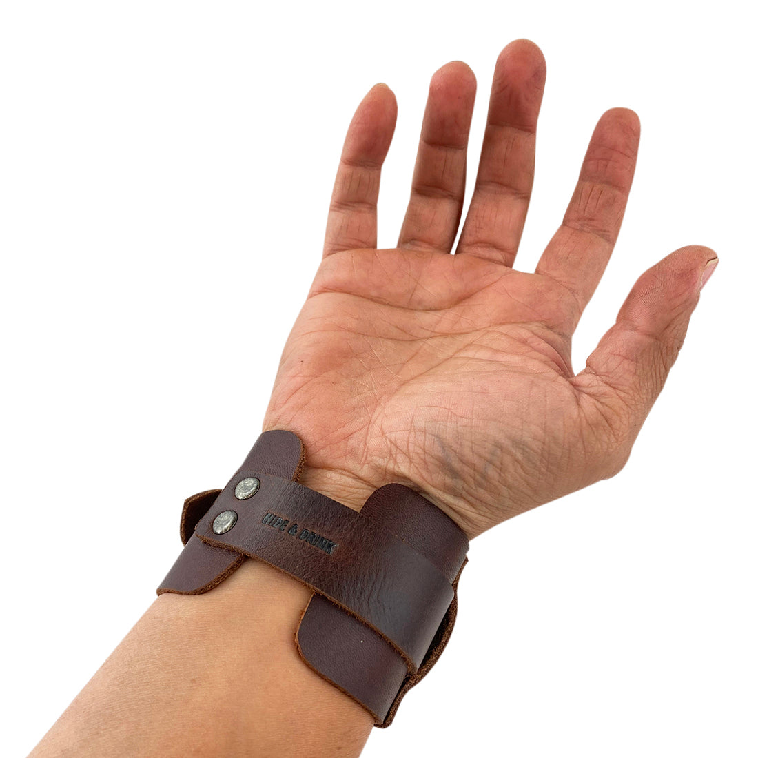 Close-up of the Hide & Drink Wristband showcasing its length and dimensions, emphasizing careful craftsmanship. This versatile Wristband with Ring Decoration Full Grain Leather reflects StockyardX's dedication to small batch production with a focus on artisan quality. Hand cut, hand sewn, and fire branded, it represents the artistry from La Antigua Guatemala & Oaxaca Mexico.