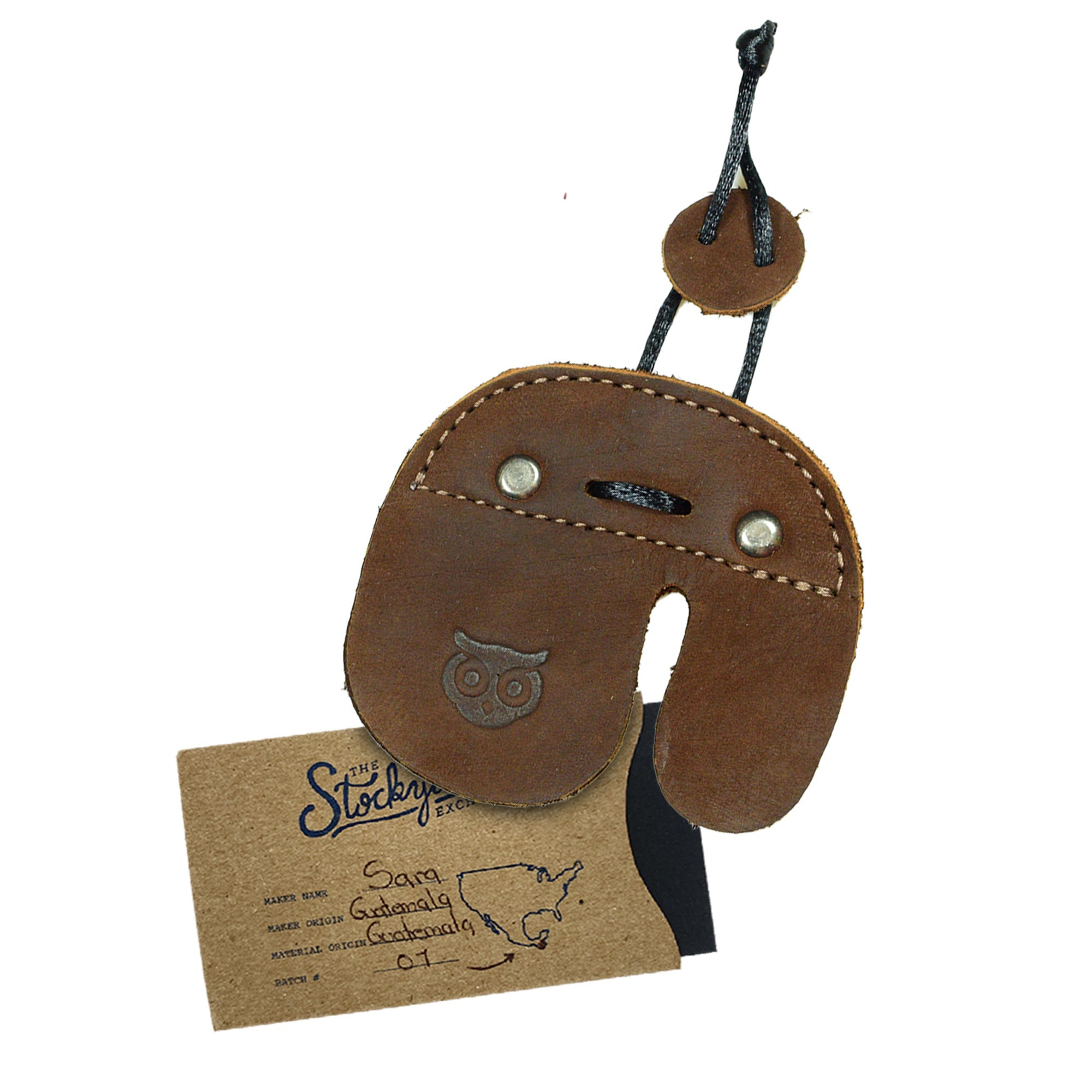 The Hide & Drink Left Handed Archery Finger Protector is displayed with a detailed view of its craftsmanship. This stylish Archery Finger Tab functions as a Protect Guard for Recurve Bows, emphasizing the use of premium Full Grain Leather. Perfect for shooting practice gear, this item highlights the small batch production ethics of StockyardX artisans.