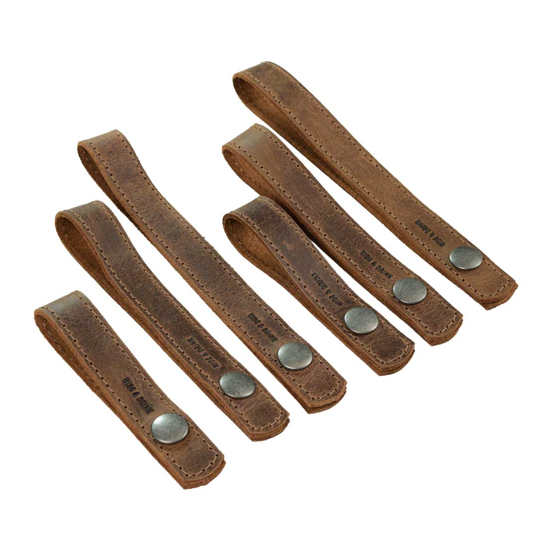 Showcase of six curtain tiebacks from Hide & Drink, perfect for enhancing home and office decors. The Curtain Tieback (6 Pack) is made from full grain leather, suitable for thin or thick window drapes. Enjoy these artisan products, handmade in La Antigua Guatemala & Oaxaca Mexico, known for their quality craftsmanship, hand cut and hand sewn finish.
