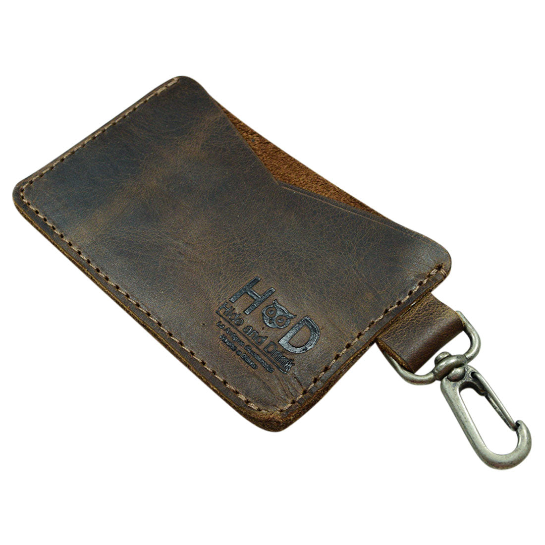 Side view of the Leather Card & Key Holder from Hide & Drink, emphasizing its minimalist design. This stylish organizer can hold up to 4 cards and serves as an efficient Keychain Organizer. Crafted from Full Grain Leather, the item is hand cut, hand sewn, and fire branded, demonstrating artisan skills from small batch production in La Antigua Guatemala & Oaxaca Mexico.