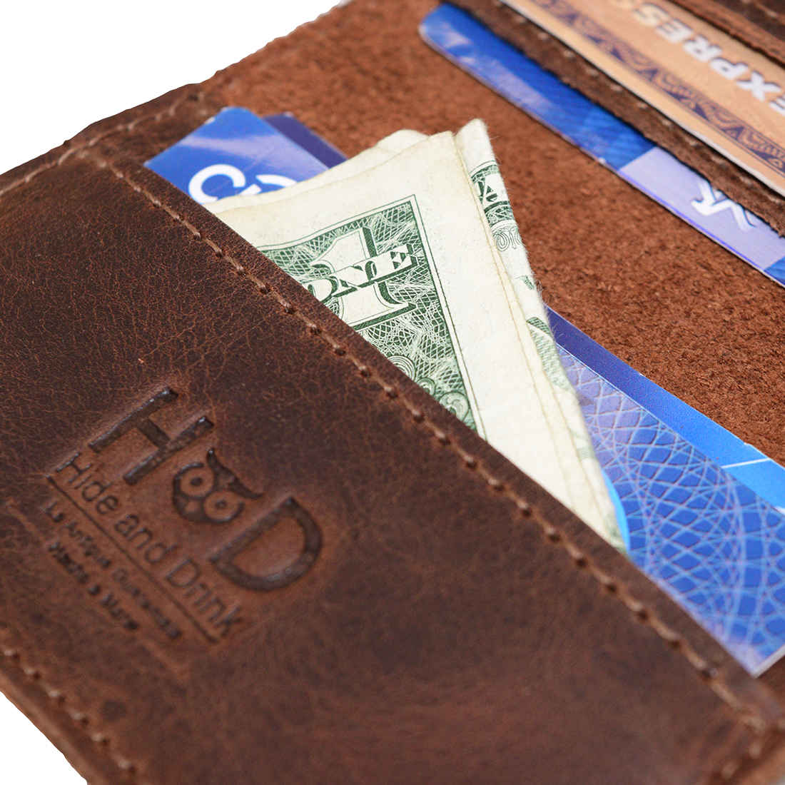 Bifold Horizontal Card Wallet by Hide & Drink, offering a glimpse of cash inside, ideal for a minimalist traveller wallet, organizer that holds up to 8 cards, made from full grain leather for a vintage feel, showcasing craftsmanship through small batch production, hand cut, hand sewn, fire branded, and artisan techniques, handmade in La Antigua Guatemala & Oaxaca Mexico.