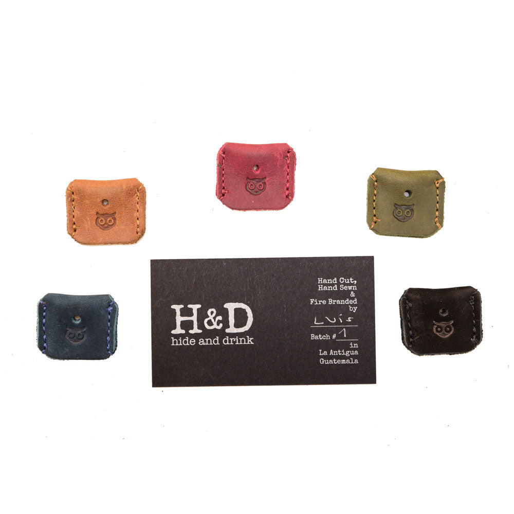 Premium Key Covers by Hide & Drink, showcasing a selection of handmade leather protectors. Each of the 5 key sleeves is crafted from full grain leather with careful attention to detail through small batch production, hand cut and hand sewn techniques, made in La Antigua Guatemala & Oaxaca Mexico.
