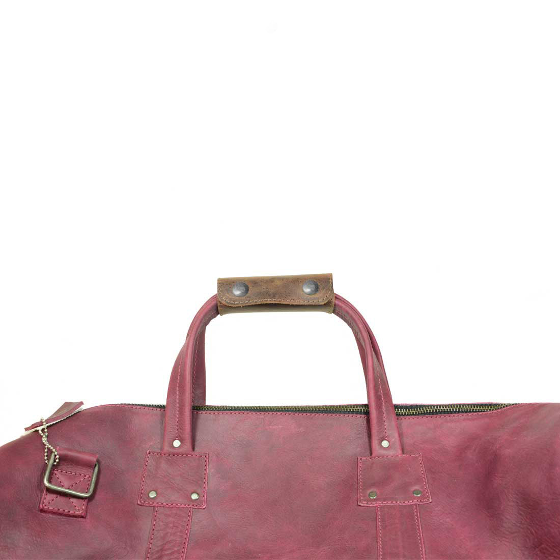 The Hide & Drink Handle Grip Replacement positioned on a bag, illustrating its functional charm in enhancing luggage usability. This Full Grain Leather piece stands out as a perfect choice for anyone seeking an authentic Handle Grip Replacement.