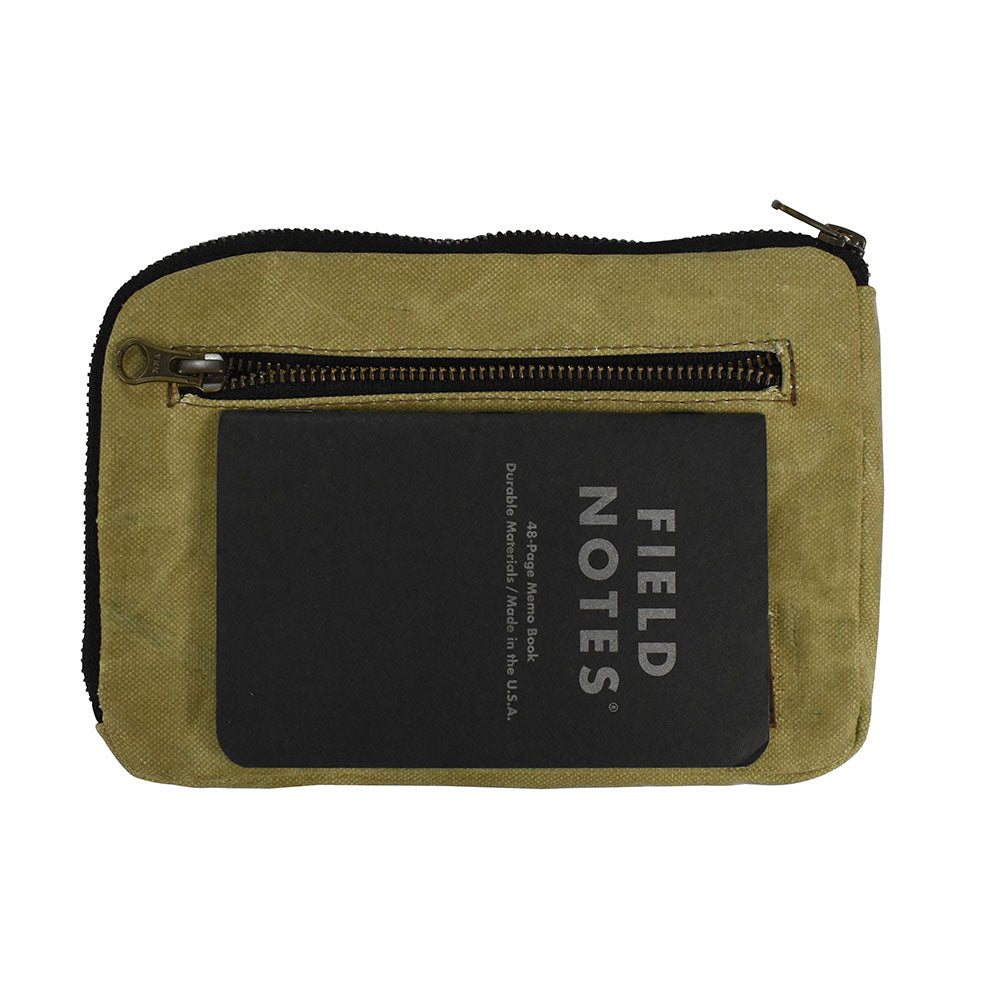 Hide & Drink's Zipper Gear Pouch with a Field Notes notebook inside, emphasizing its practicality and handmade quality, crafted from durable water resistant waxed canvas.