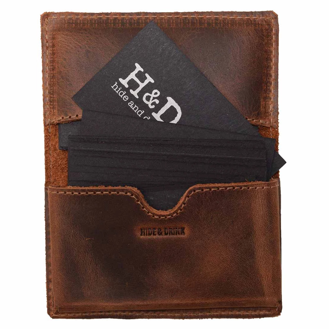 Hide & Drink's Vintage Card Holder featuring business cards neatly housed, embodying a blend of style and functionality. This vintage business card holder doubles as a cash organizer and wallet, crafted from full grain leather in small batches by artisans in La Antigua Guatemala & Oaxaca Mexico.
