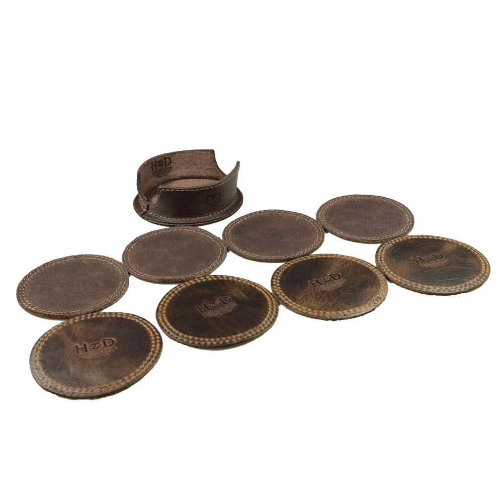 Featuring the Circles Coaster (8-Pack) by Hide & Drink, with coasters arranged neatly beside a coffee cup. This set offers stain protection and is ideal for various settings including kitchens and bars, crafted in La Antigua Guatemala and Oaxaca Mexico.