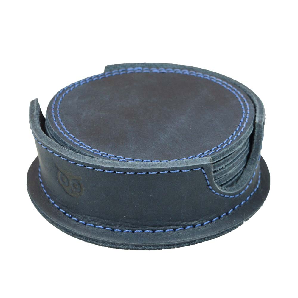 Displayed Thick Leather Coasters (6-Pack) by Hide & Drink in blue slate, highlighting the circular design of these coasters made from full grain leather. Each piece embodies artisan craftsmanship, made through small batch production, hand cut, hand sewn, and fire branded, crafted by artisans in La Antigua Guatemala.