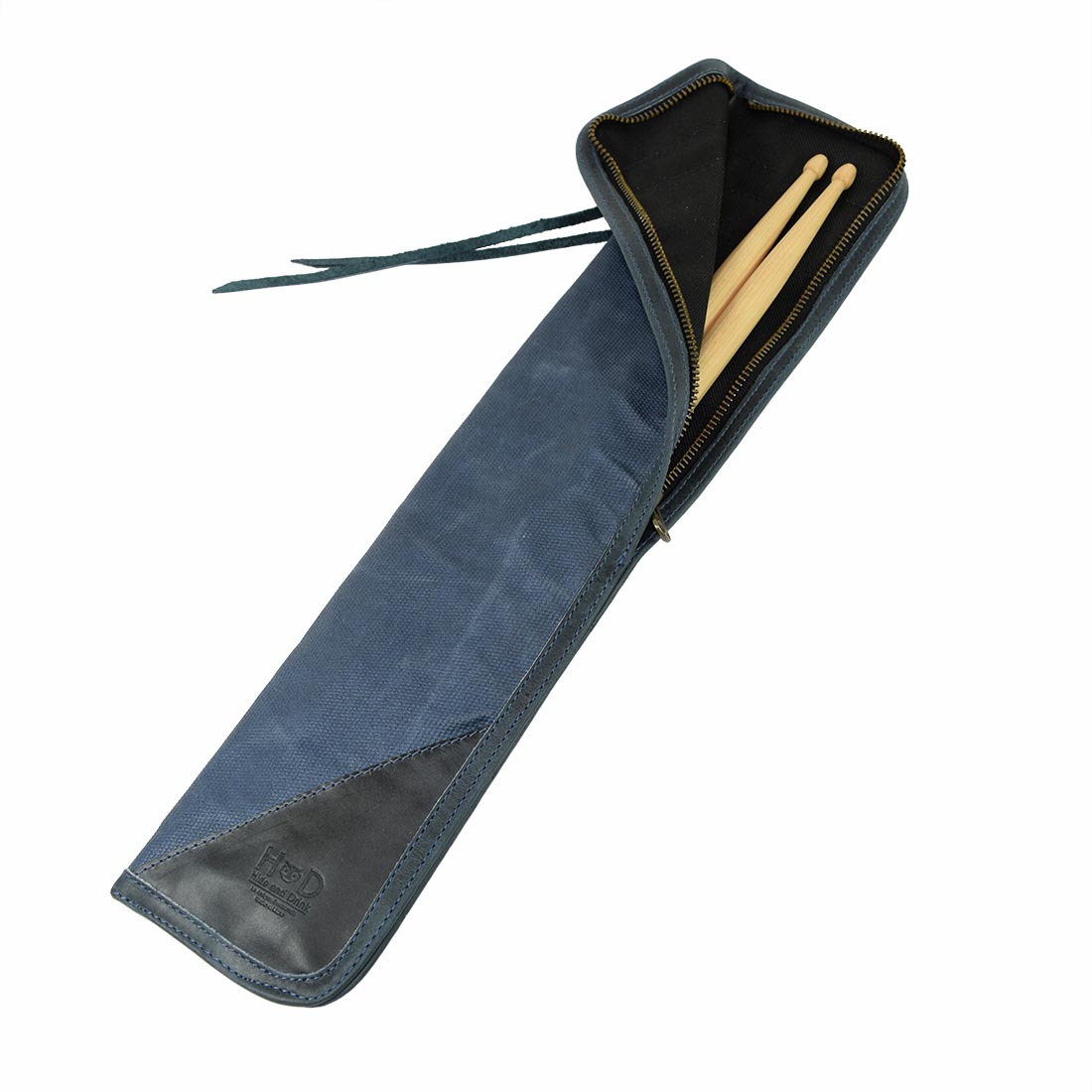 Open view of the blue Hide & Drink Drummstick Bag with drumsticks placed inside, showcasing its secure design. Made from Waxed Canvas & Full Grain Leather, this Drumstick Bag Holder is essential for any drummer, emphasizing artisan craftsmanship and small batch production from La Antigua Guatemala & Oaxaca Mexico.