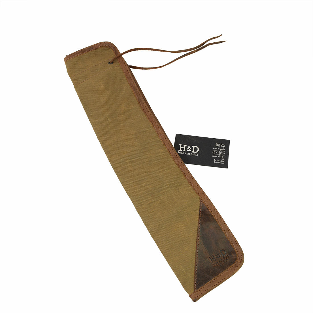 The Hide & Drink Drummstick Bag displayed with an informational tag, featuring elegant Waxed Canvas & Full Grain Leather material. This Drumstick Bag Holder is a must-have for musicians, highlighting the commitment to small batch production, hand cut and hand sewn craftsmanship in La Antigua Guatemala & Oaxaca Mexico.