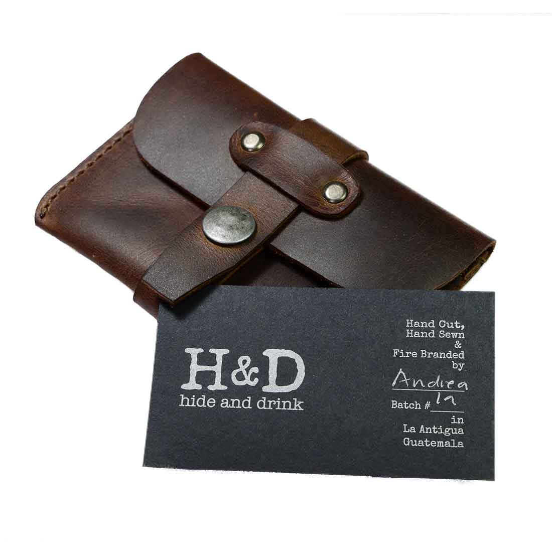 Hide & Drink's Credit Card Holder with a branded tag displayed, emphasizing the handmade quality and small batch production from La Antigua Guatemala. This Full Grain Leather card holder is perfect for anyone seeking a stylish, minimalist wallet.