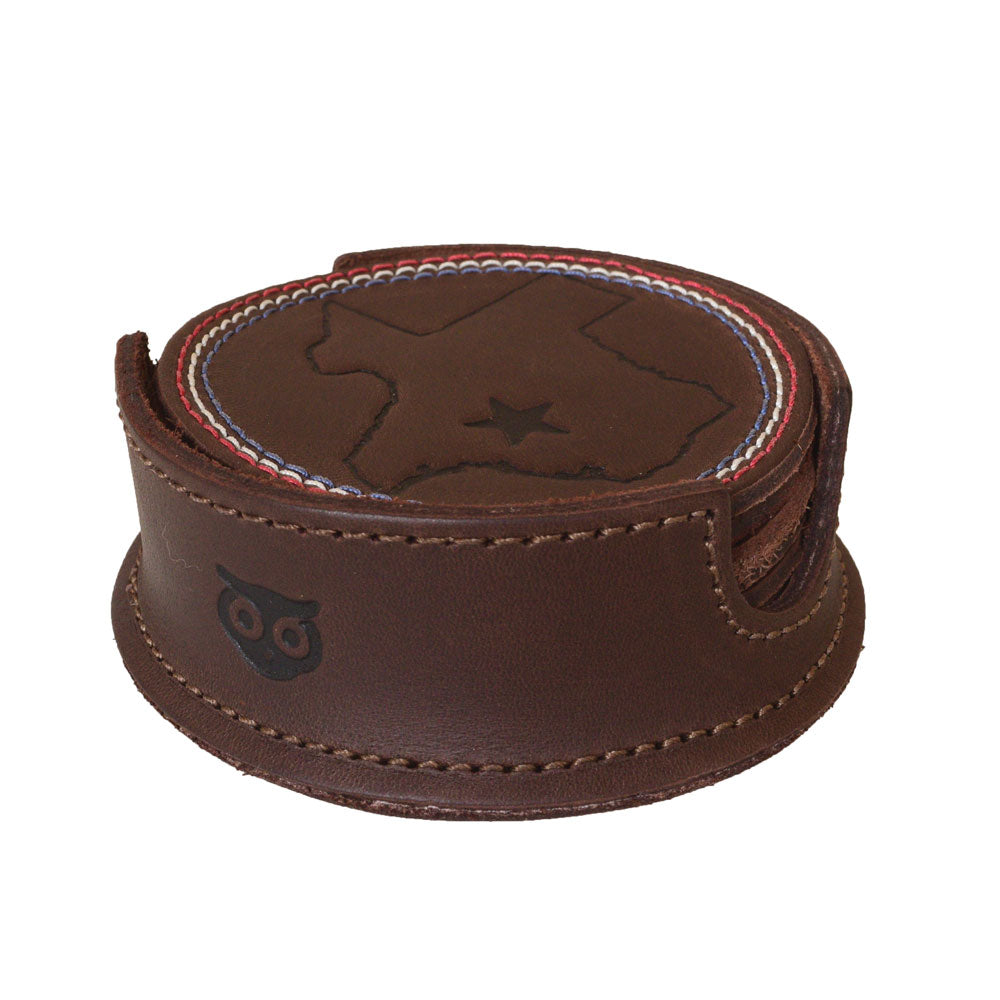Texas State Coasters with Stitching (6-Pack) by Hide & Drink displaying a full set of rustic leather coasters in a holder, featuring Texas state insignia. These coasters offer durable protection for surfaces during drinks. Set of 6 Coasters for Drinks with Texas State Design, Glass and Cups Stain Protection, Full Grain Leather, StockyardX, Small Batch Production, Hand Cut, Hand Sewn, Fire Branded, Artisan, Handmade in La Antigua Guatemala & Oaxaca Mexico.
