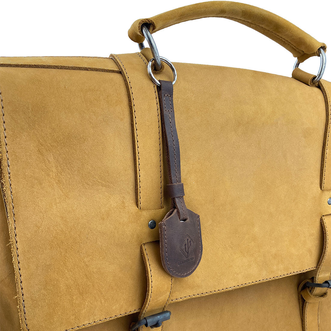 The LeatherTex Rustic Strap Keyring for AirTag attached to a stylish bag. This keychain holder for car and home is a versatile key organizer accessory, fabricated from full grain leather with artisan craftsmanship, reflecting the quality of small batch production in La Antigua Guatemala.