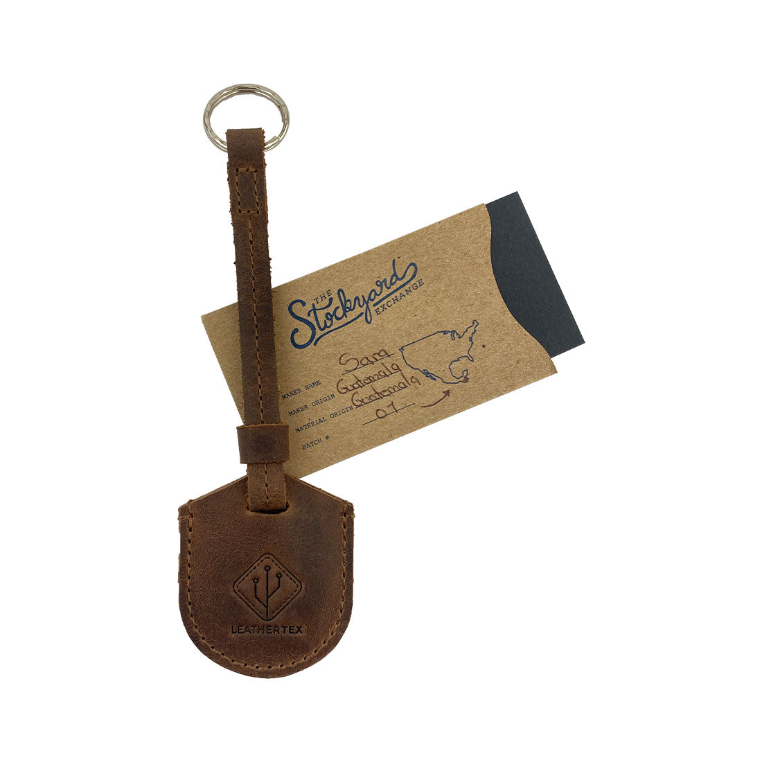 LeatherTex Rustic Strap Keyring for AirTag presented with its business card, demonstrating its uniqueness as a keychain holder for car and home. This key organizer accessory is crafted from premium full grain leather, highlighting the artisan creation in La Antigua Guatemala and Oaxaca Mexico.