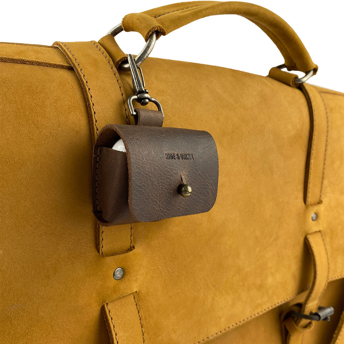 Airpods Pro Case Keychain by Hide & Drink - Attached to a leather bag, this stylish case exemplifies convenience and protection. Ideal for travel or daily use, this full grain leather accessory is handmade in La Antigua Guatemala & Oaxaca Mexico with artisan craftsmanship.