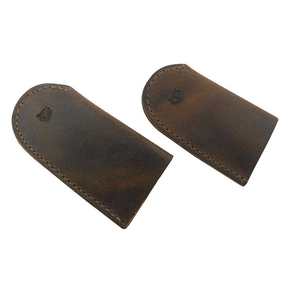Leather Thimble for Thumb & Index Finger (3 Paires) by Hide & Drink showing two leather thimbles from the set of 3 pairs (6 pieces). These thimbles act as finger protectors and are perfect for sewing, hand appliqué, EPP, and quilting. Crafted from premium full grain leather, StockyardX presents these artisan, handmade thimbles, featuring a hand cut and hand sewn finish, made in La Antigua Guatemala & Oaxaca Mexico.