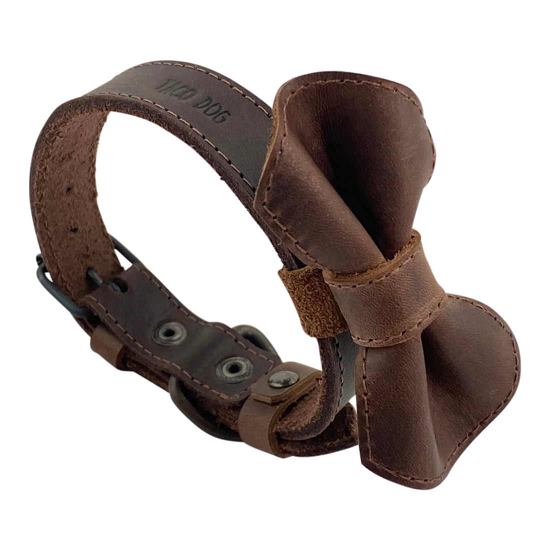 Side view of Taco Dog's Leather Bow Tie Collar, showcasing its exquisite bow design and durable leather material. This artisan pet accessory is handmade in La Antigua Guatemala, ideal for small dogs and puppies. Embrace the beauty of handcrafted craftsmanship with this lovely rustic collar for your furry friend.