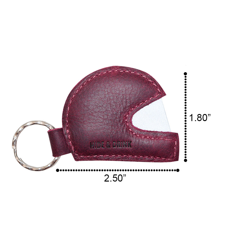 Product dimensions of the Hide & Drink Motorcycle Helmet Keychain, indicating its compact size. This well-crafted leather keychain serves as a trendy holder for motorcycle keys, merging functionality and artisan quality with a fashionable design.