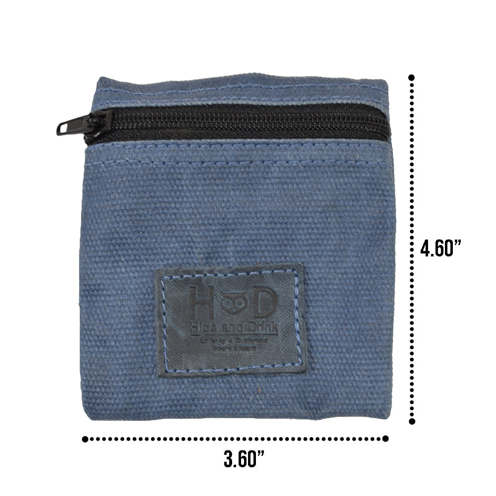 Hide & Drink Condom Pouch featuring earphones and a memory card, made from premium water resistant waxed canvas. This pocket purse is a practical solution for tech and a charming classic partner gift. Handcrafted in La Antigua Guatemala highlights artisan quality.