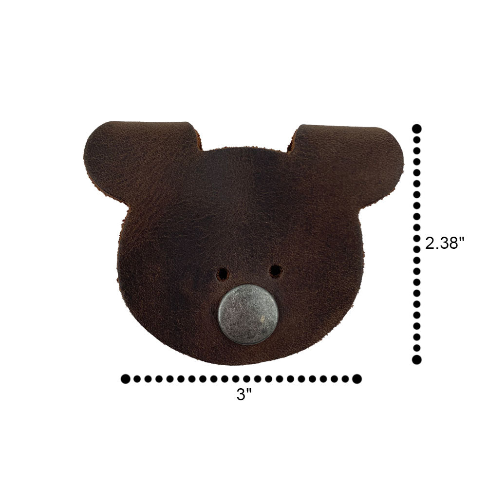 Back view of a Bear Shaped Cord Keeper (Cord Clam) by Hide & Drink, illustrating the craftsmanship in Full Grain Leather with fire branded details. Handmade in La Antigua Guatemala & Oaxaca Mexico, representing small batch production.