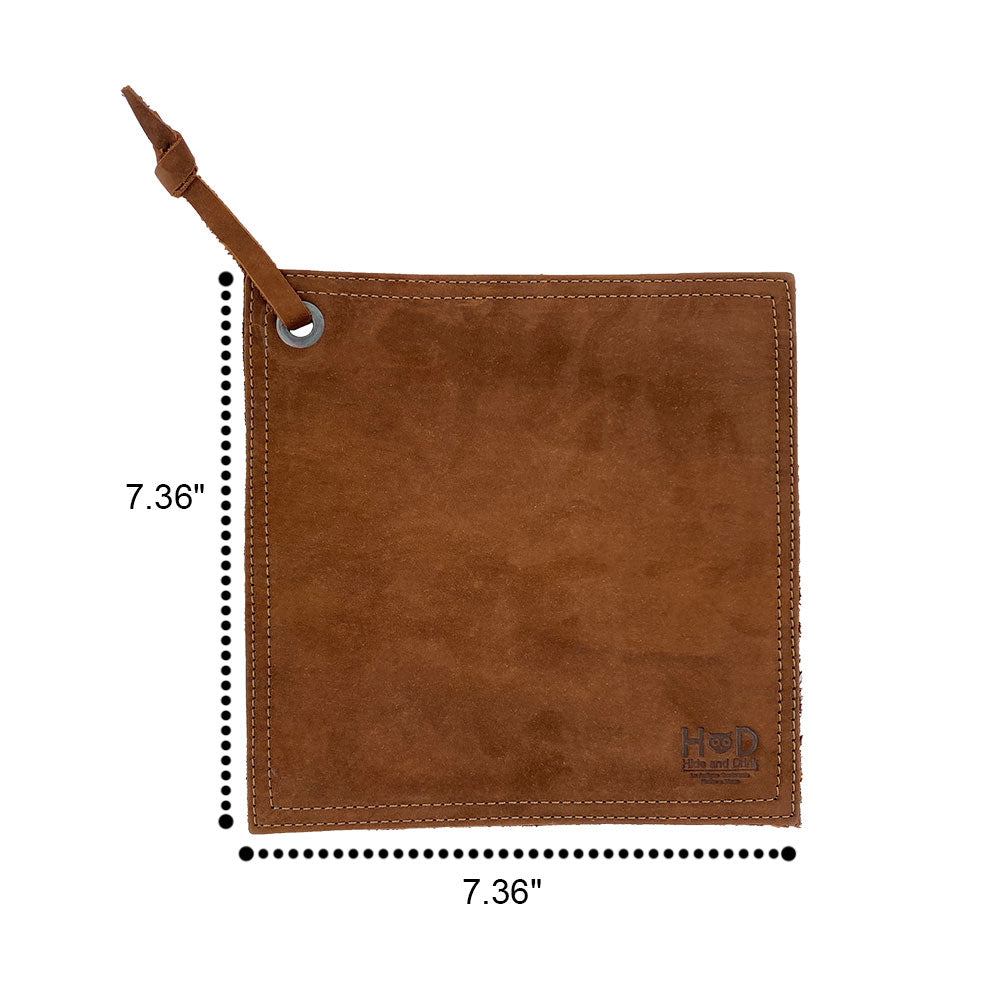 Measuring dimensions of the Hide & Drink Pot Pad, featuring its double-layered design. This artisan potholder, made of full grain leather, is perfect for handling hot cookware safely.