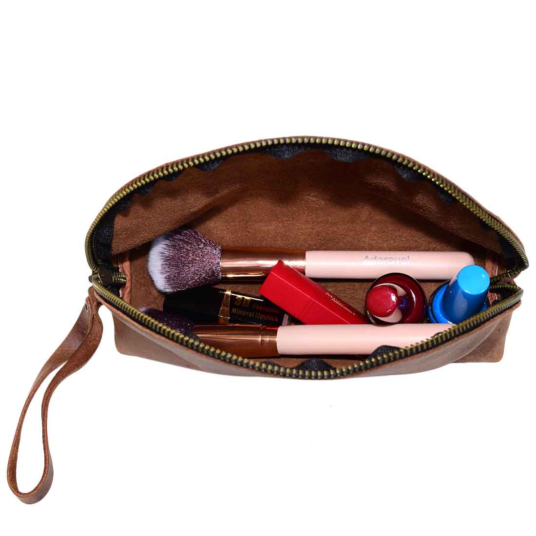 Inside view of the Accessory Pouch Organizer Hand Bag by Hide & Drink, filled with cosmetics. This artistic Cosmetic Travel Organizer with Hand Strap for Women is the perfect Makeup Bag or Classic Handbag crafted from durable full grain leather. Handmade and fire branded, it embodies artisan craftsmanship from La Antigua Guatemala & Oaxaca Mexico.