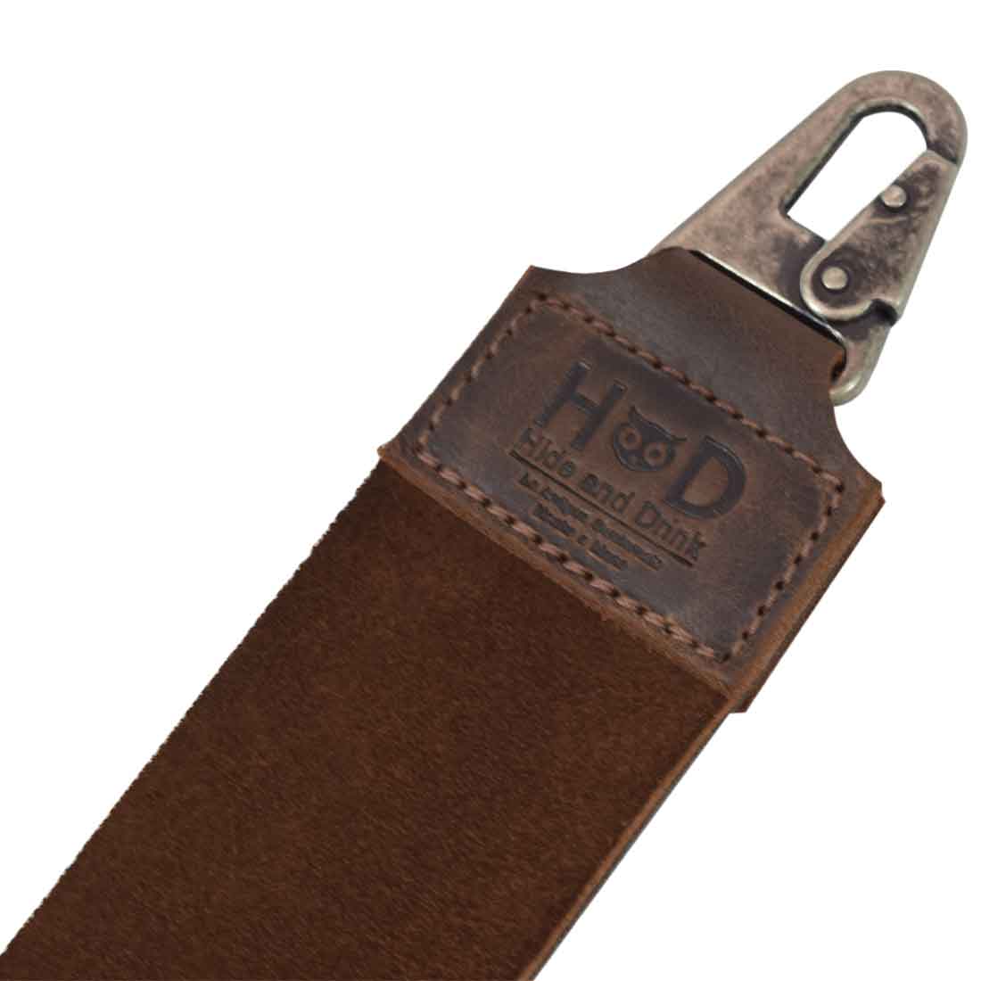The clip attachment on Hide & Drink's Barber Strop, emphasizing the blend of functionality and style. This Full Grain Leather shaving sharpener is perfect for barbers needing a reliable Razor Strop and Barber Straight Razor Strap Belt, made with artisan care.