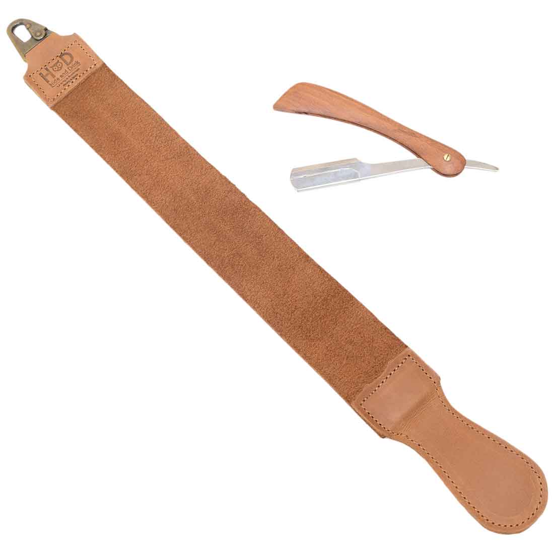 Hide & Drink's Barber Strop displayed with a straight razor, featuring a lighter aesthetic. This Full Grain Leather shaving sharpener emphasizes artisan quality and serves as both a Razor Strop and Barber Straight Razor Strap Belt.