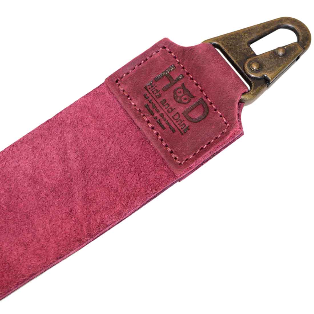 The clip attachment on Hide & Drink's purple Barber Strop, ideal for barbers. This Full Grain Leather shaving sharpener also works as a Razor Strop, reflecting artisan quality and design.