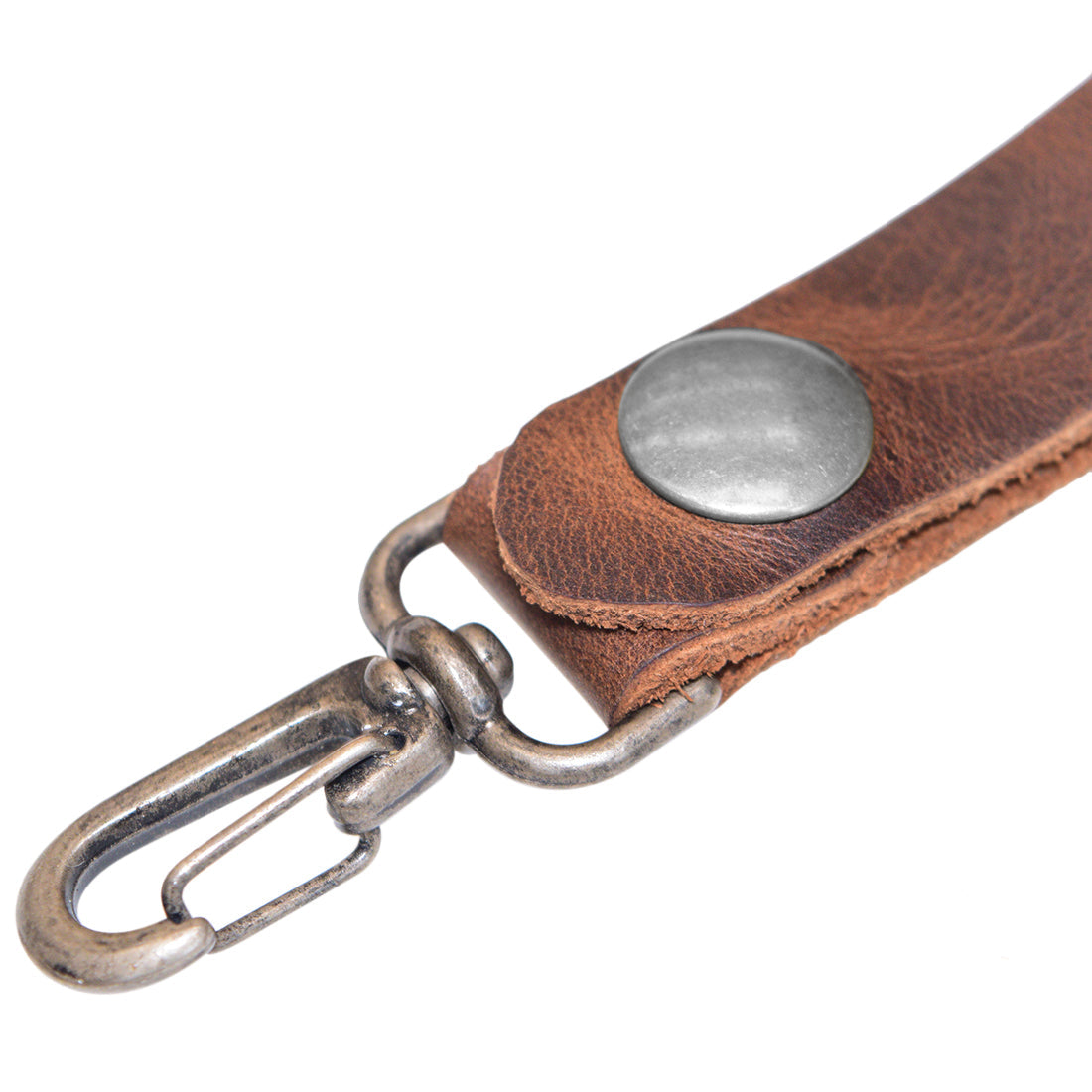 Close-up of Belt Key Holder by Hide & Drink featuring a metal snap and strong clip, designed for durability. Dimensions Length: 4.25 in. Height: 1 in. Width: 0.50 in. The Full Grain Leather gains a unique patina over time and can be maintained with mineral oil or beeswax leather conditioner.