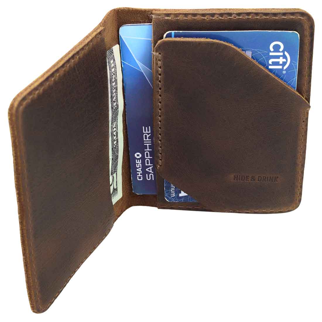 Bi-Fold Card Wallet Diagonal by Hide & Drink with cards inserted, illustrating its capacity to hold up to 5 cards plus folded bills, along with stylish full grain leather craftsmanship, a true accessory for anyone.