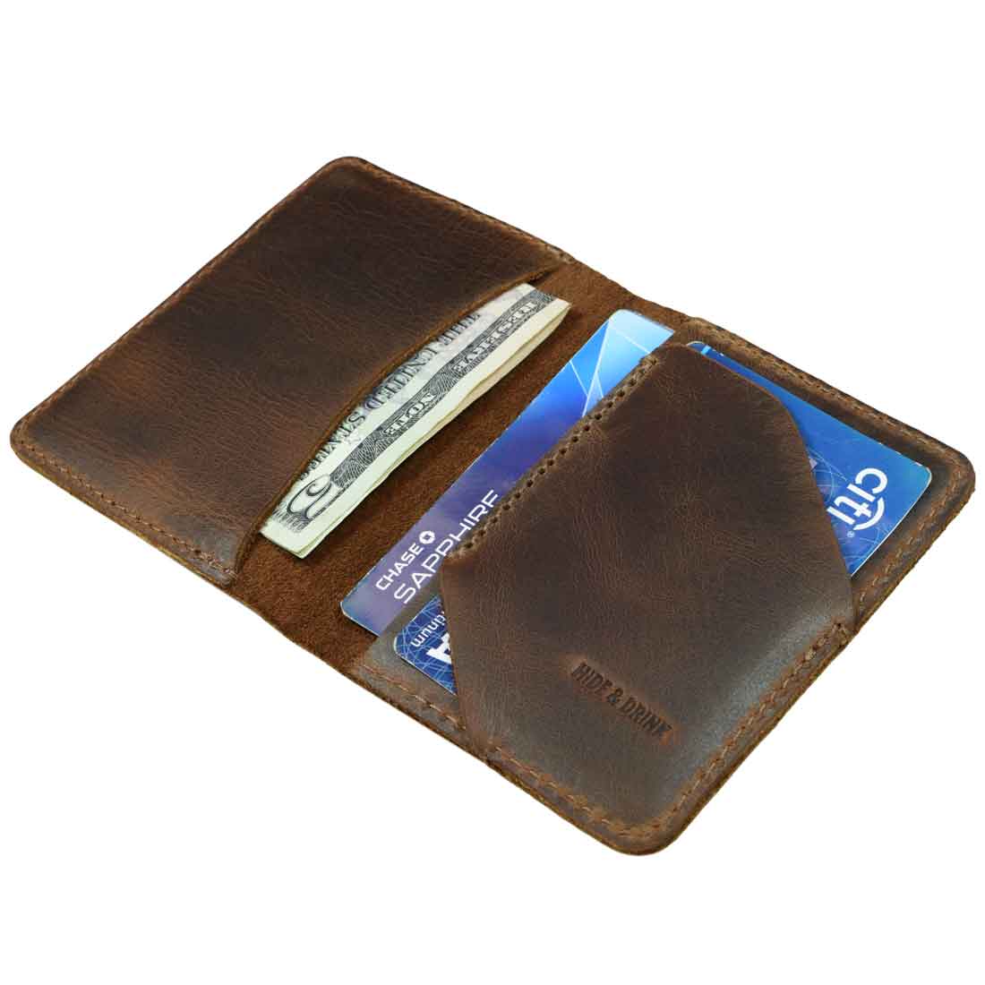 Bi-Fold Card Wallet Diagonal by Hide & Drink opened up to show cards and cash, designed for organization with a sleek aesthetic, made from artisan-quality full grain leather, perfect for everyday accessories.