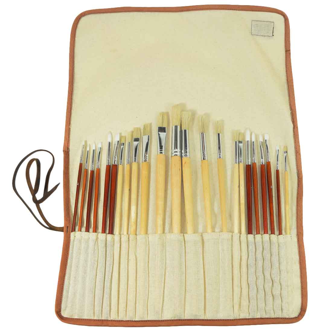 Paint Brush Roll-Up by Hide & Drink in use, displaying a rich assortment of brushes in the tailored storage wrap. This Artist Paint Brush Canvas Roll-Up with Leather Lining Storage Wrap / 24 Slots / Workshop Art Study highlights small batch artisan craftsmanship. Fire branded and handmade in La Antigua Guatemala & Oaxaca Mexico.