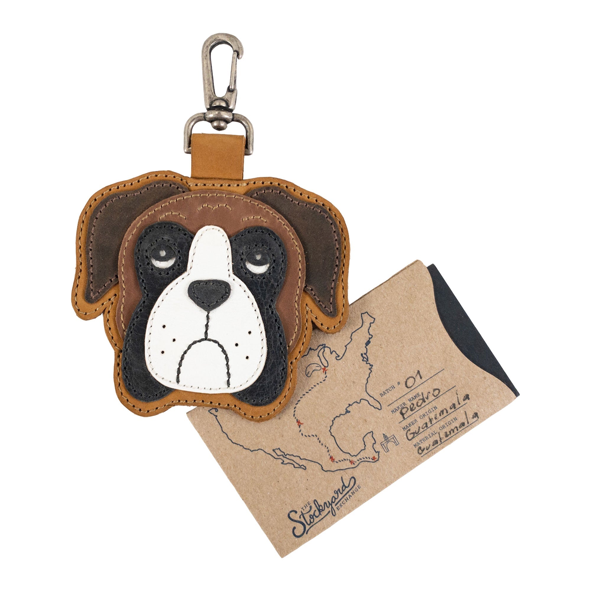 Boxer Face Charm by TACO DOG alongside an informative card showcasing its artisanal roots. Made from Full Grain Leather, this charming accessory is a product of small batch production and is hand cut and hand sewn, proudly crafted in La Antigua Guatemala & Oaxaca Mexico.