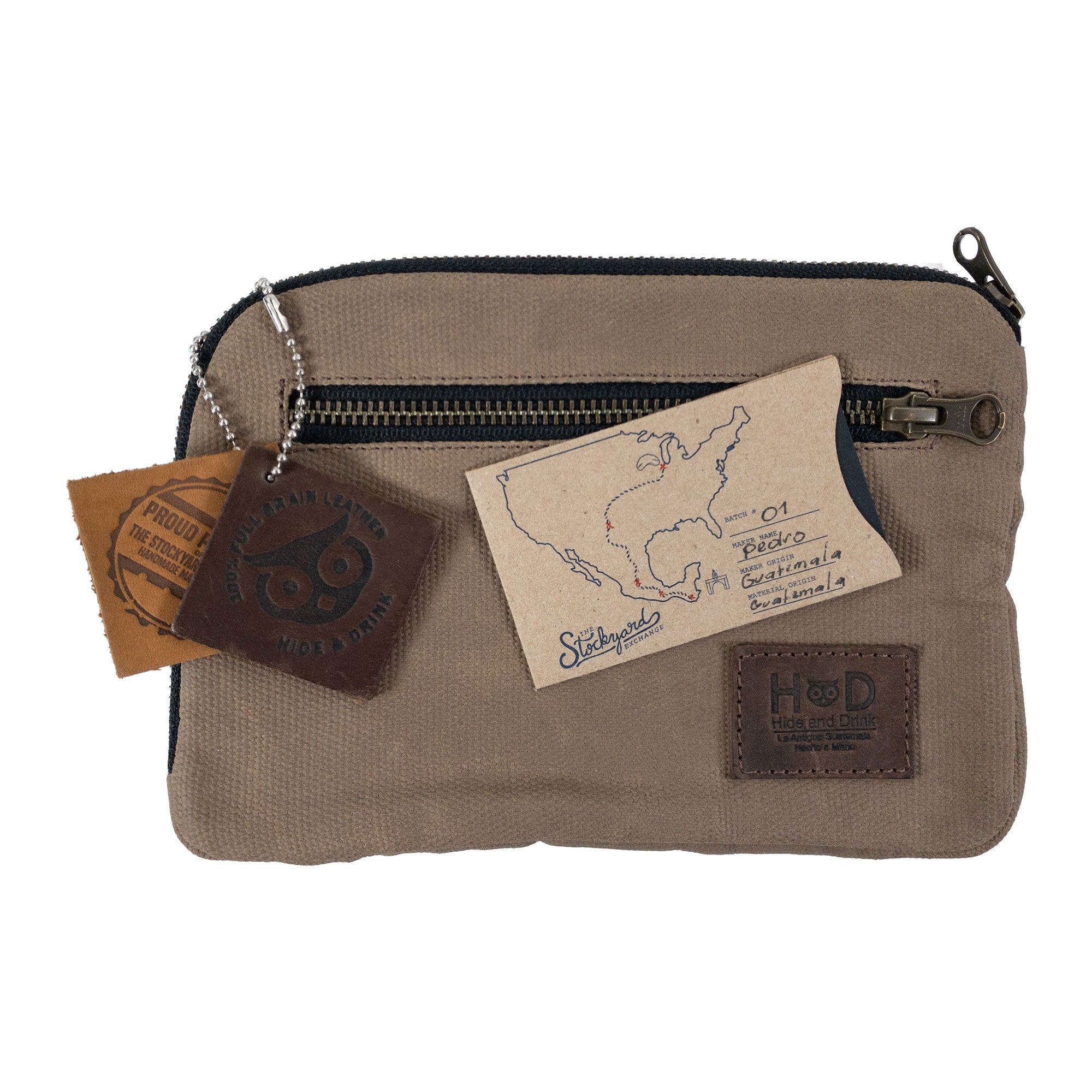 Hide & Drink's Zipper Gear Pouch with artisan craft tags, signifying its handmade quality and unique design, made from durable water resistant waxed canvas.