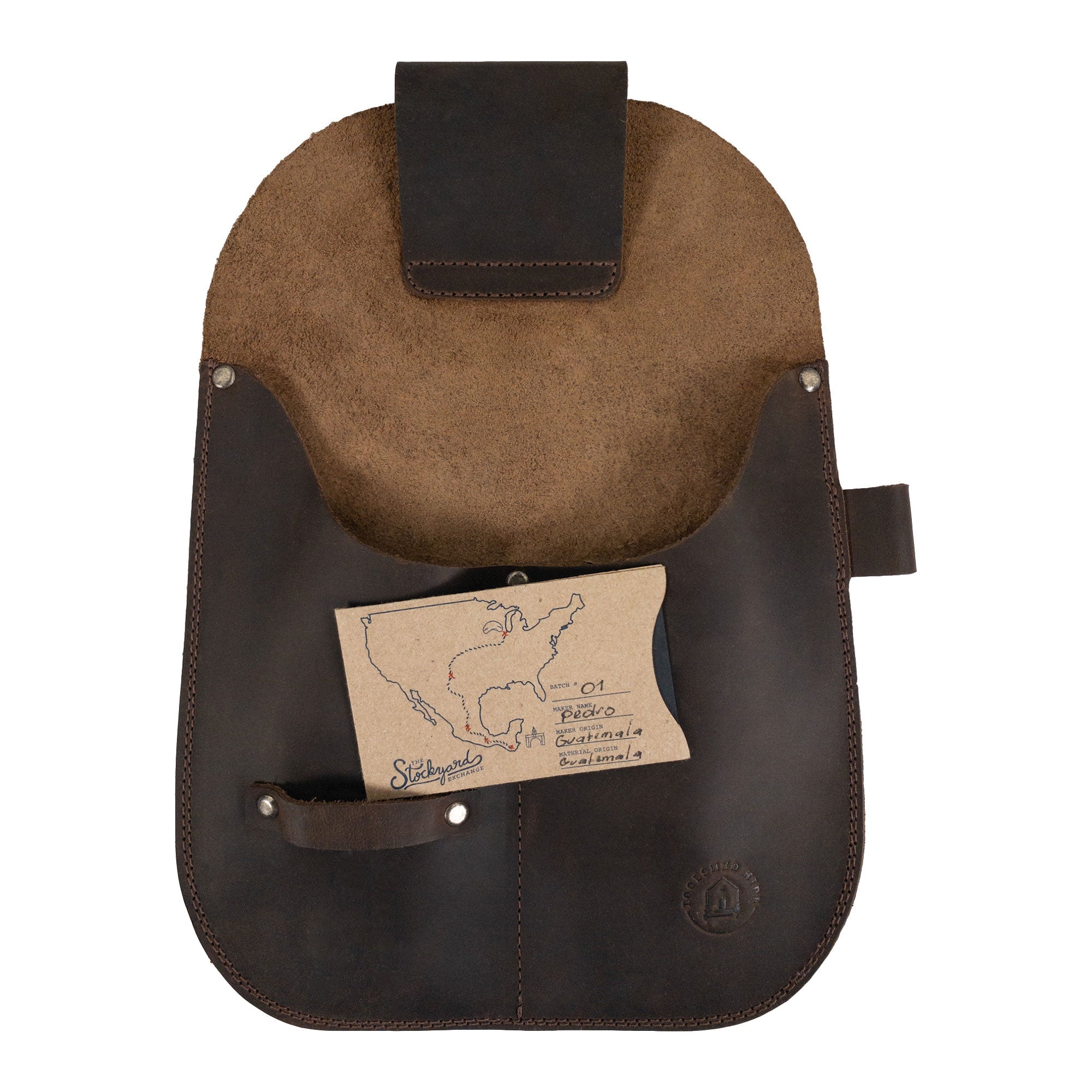 Gardening Tool Holder by Toolshed Hide displayed with informational materials, demonstrating its unique design. This functional Gardening Tool Holder, crafted from full grain leather, highlights its small batch production, featuring hand cut, hand sewn characteristics and authentic fire branded details by artisans. Handmade in La Antigua Guatemala & Oaxaca Mexico.