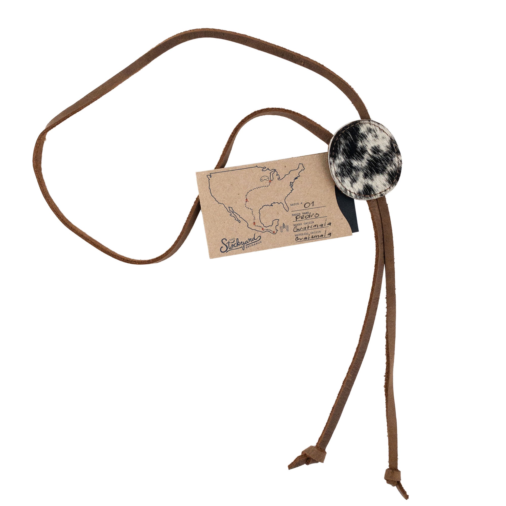 Cowboy Bolo Tie by Western Leather Works presented with tag and round shape crafted from full grain leather. This necktie costume accessory highlights artisan craftsmanship through small batch production, handmade in La Antigua Guatemala & Oaxaca Mexico.