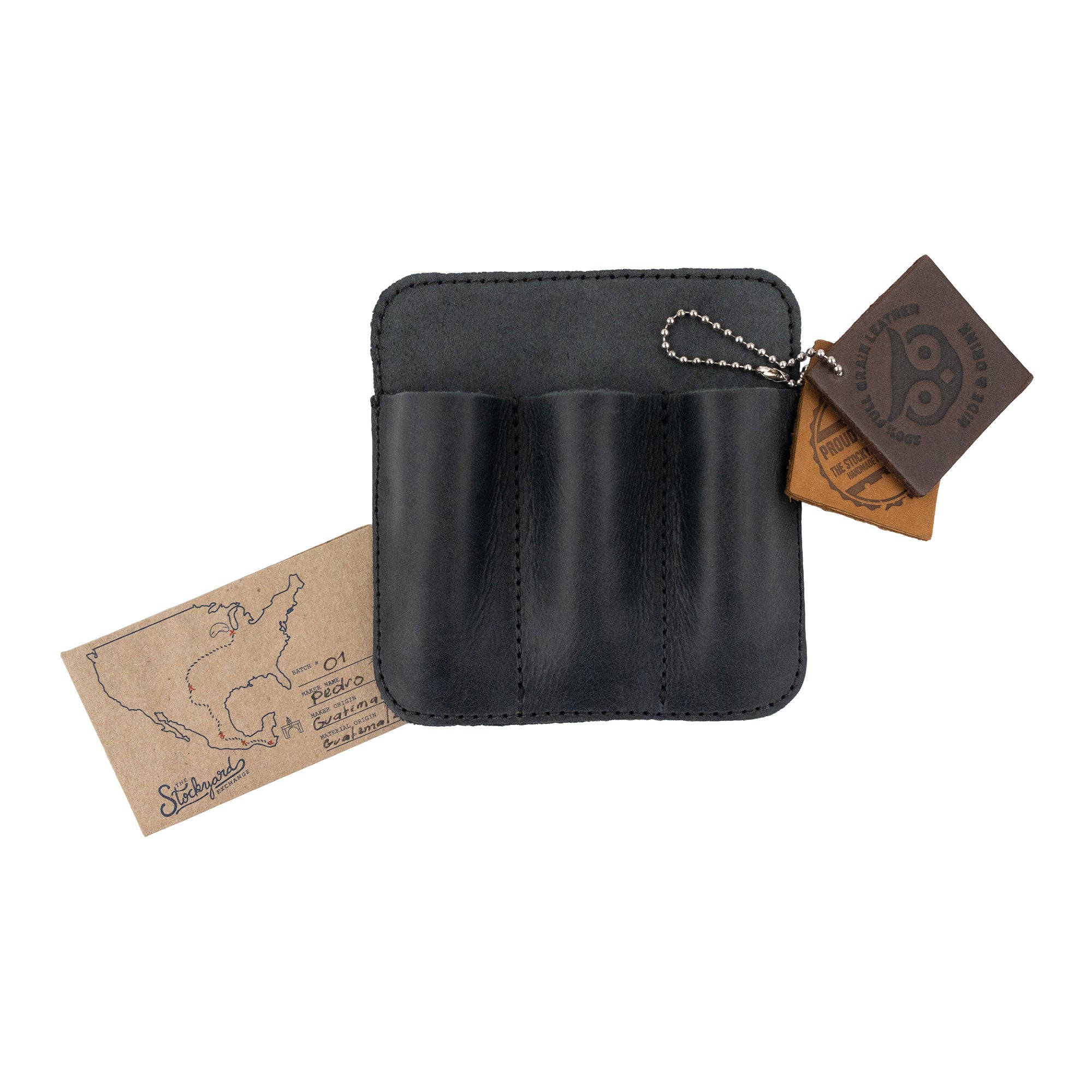 Hide & Drink Minimalist Tool Pocket alongside its tags representing its origins. This Full Grain Leather Tool Pocket Pouch signifies quality and craftsmanship, being handmade in La Antigua Guatemala under the values of StockyardX and small batch production.