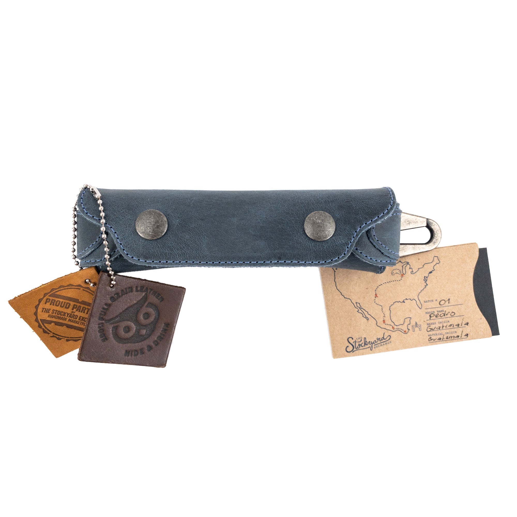 Harmonica Case with attached tags from Hide & Drink, highlighting its unique artisan quality. Made from full grain leather, this vintage style protector is essential for musicians, representing small batch production from La Antigua Guatemala.