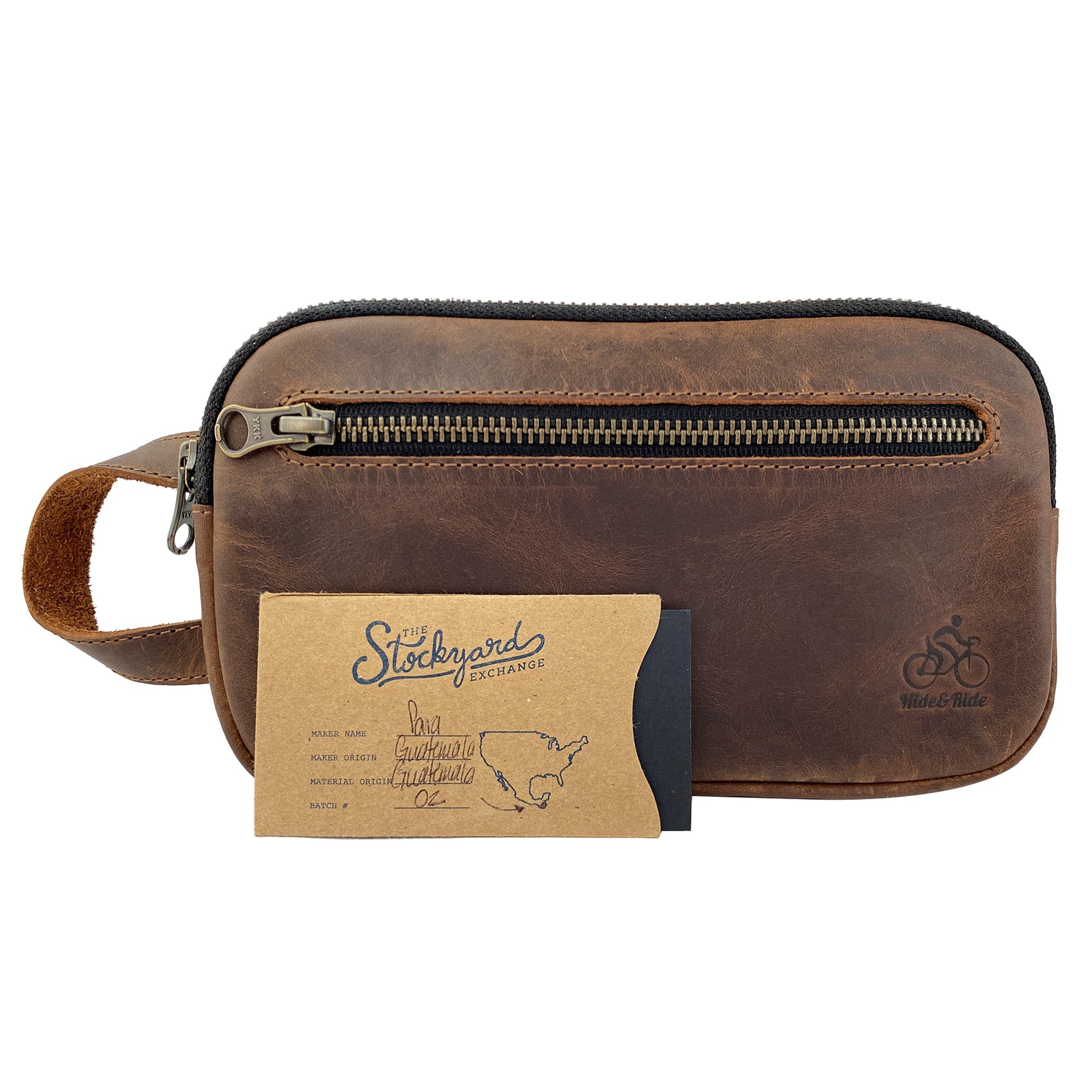 Hide & Ride Cycling Phone Bag alongside a card, highlighting its quality craftsmanship and practical design. This durable pouch serves as a utility bag for small tools and chargers, made from full grain leather and artisanal techniques from La Antigua Guatemala.
