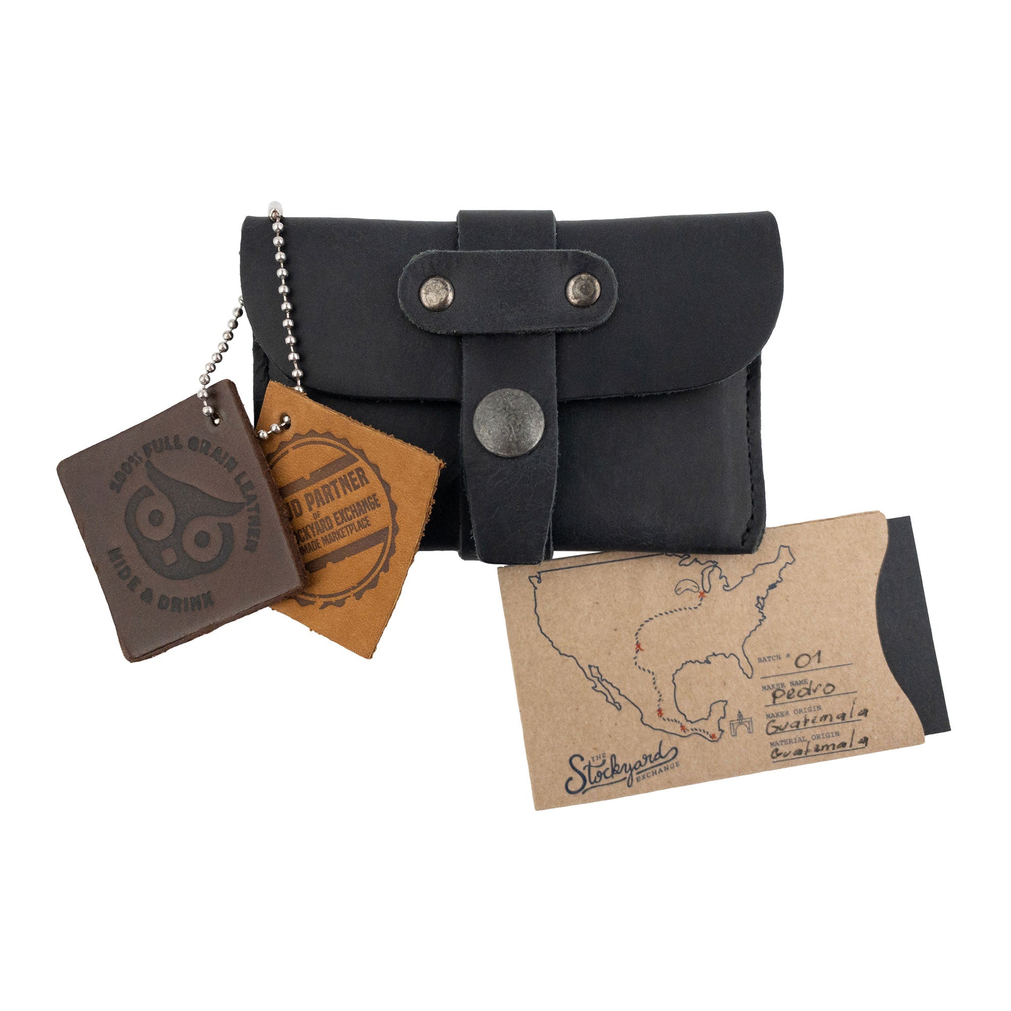 Hide & Drink's Credit Card Holder displayed with accompanying tags illustrating its artisan quality. Made from Full Grain Leather, this minimalist front pocket wallet represents craftsmanship from La Antigua Guatemala, merging style and function.